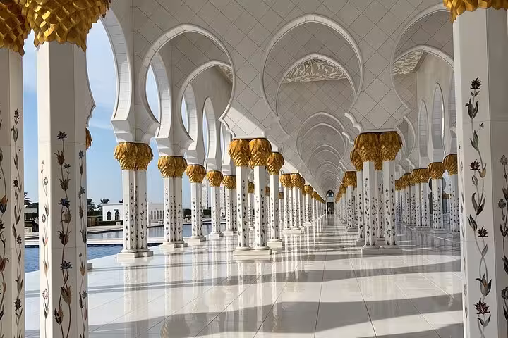 Sheikh Zayed Grand Mosque colonnade with floral pillars, Abu Dhabi city tour highlight with Ferrari World