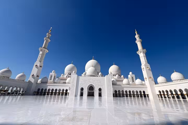 Sheikh Zayed Grand Mosque exterior on Abu Dhabi city tour from Ras Al Khaimah, white domes and minarets