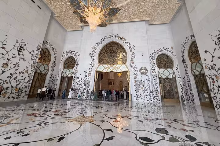 Sheikh Zayed Grand Mosque interior hall on Abu Dhabi tour from Ras Al Khaimah, floral marble and chandeliers