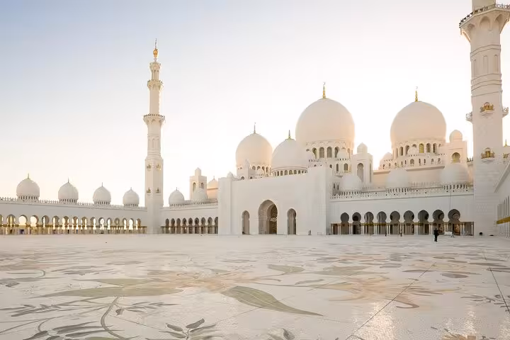 Sheikh Zayed Grand Mosque white domes and courtyard, iconic landmark on a private full-day Abu Dhabi city tour