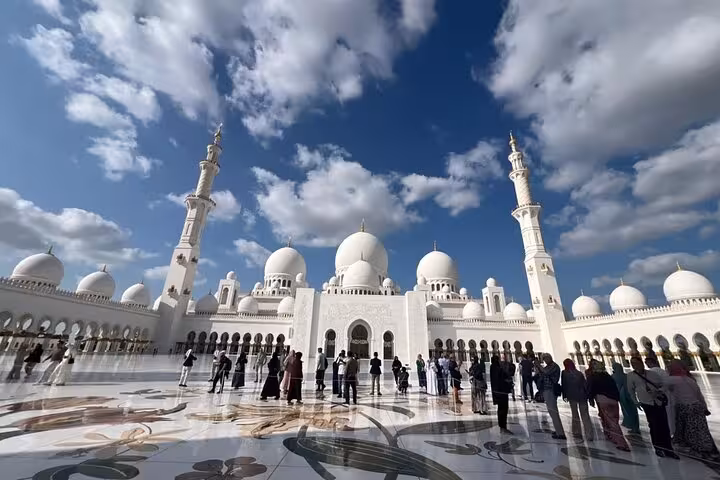 Sheikh Zayed Grand Mosque courtyard with domes and minarets, Dubai to Abu Dhabi multi day tour