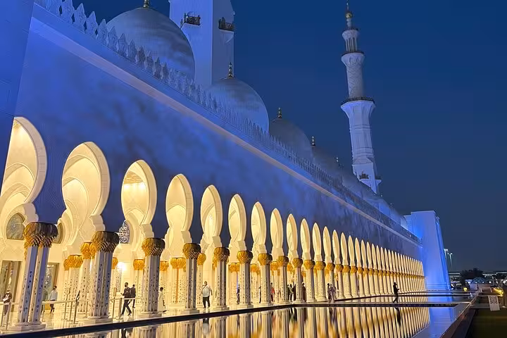 Sheikh Zayed Grand Mosque Abu Dhabi at sunset, glowing arches and reflection pool on guided visit