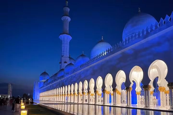 Evening view of Sheikh Zayed Grand Mosque colonnade and domes, Abu Dhabi guided sunset visit experience