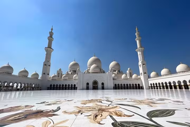 Sheikh Zayed Grand Mosque Abu Dhabi courtyard view with domes and marble floor, ideal sunset tour stop