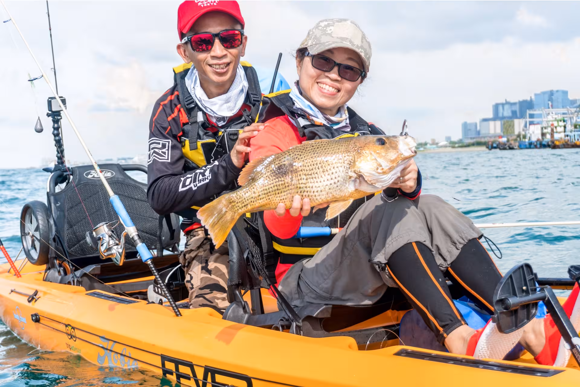 Smiling anglers display their catch during a thrilling kayak fishing adventure at Shipwreck Bay, Marine East.