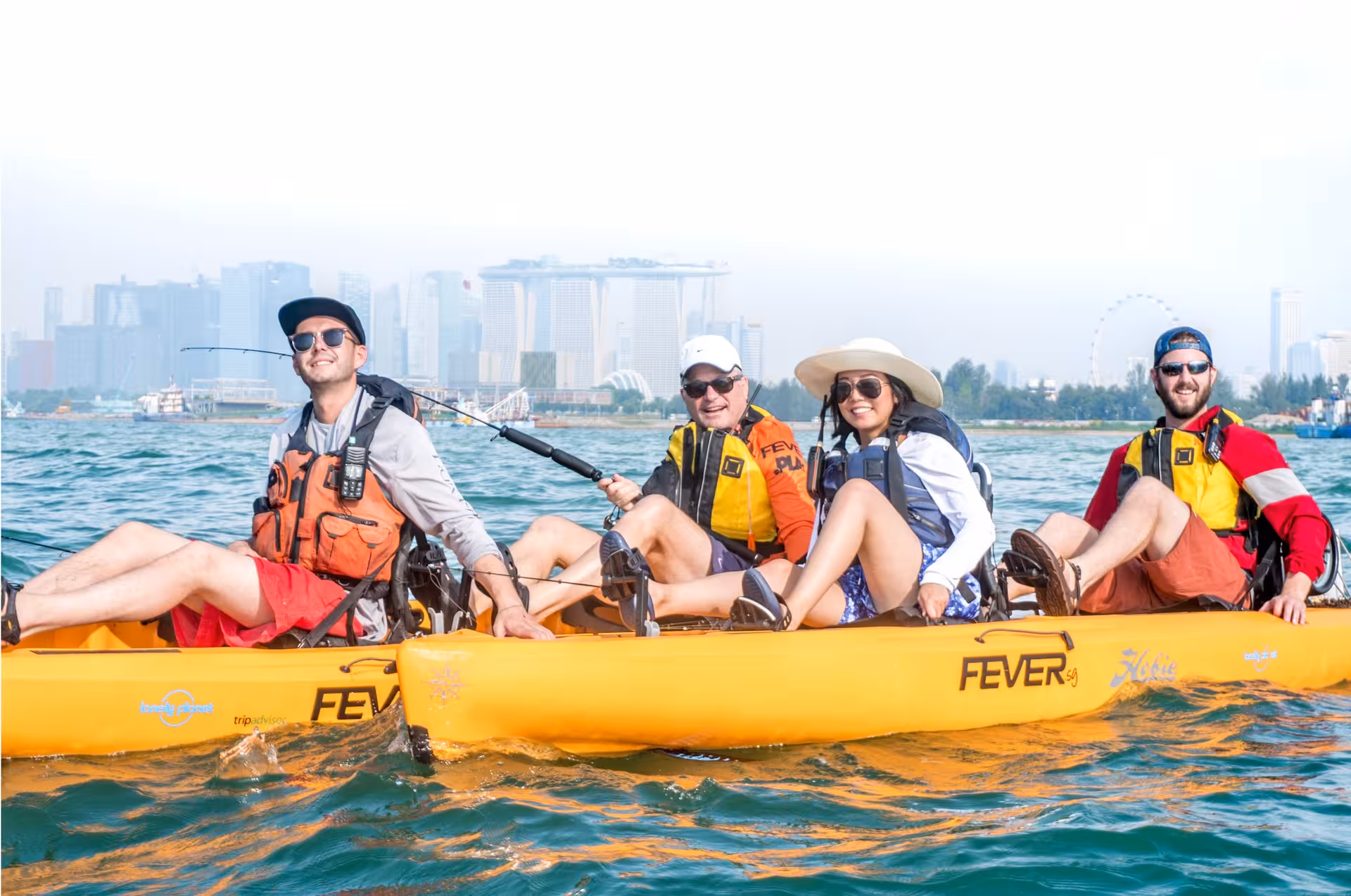 Group of friends enjoy kayak fishing with a city skyline backdrop at Shipwreck Bay, Marine East.