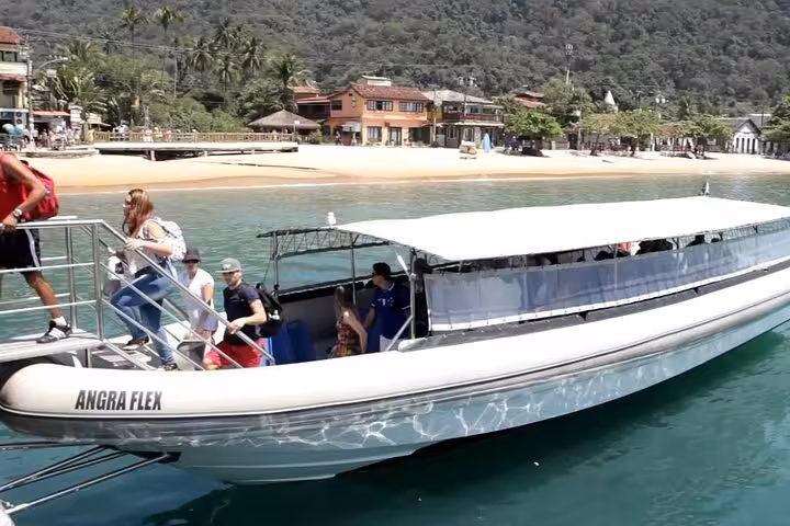 Tourists boarding a sleek shuttle boat at Angra dos Reis, heading to the picturesque beaches of Ilha Grande.