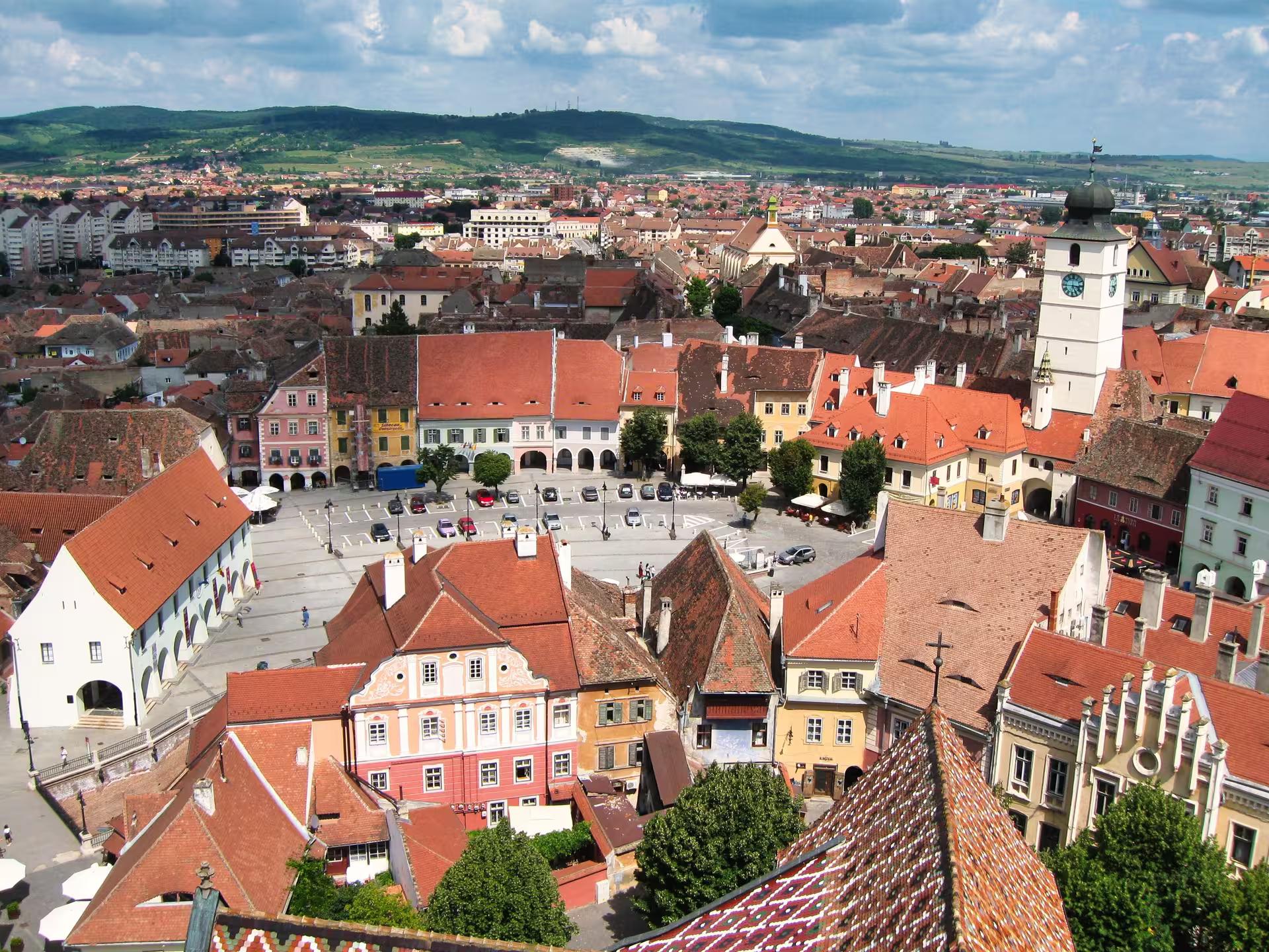Aerial panoramic view of Sibiu old town red rooftops and Council Tower on a Transylvania day trip