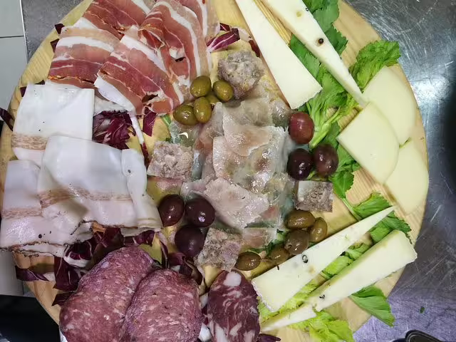Sicilian lunch platter with cured meats, local cheeses and olives on Full-Day Etna Jeep Tour from Taormina