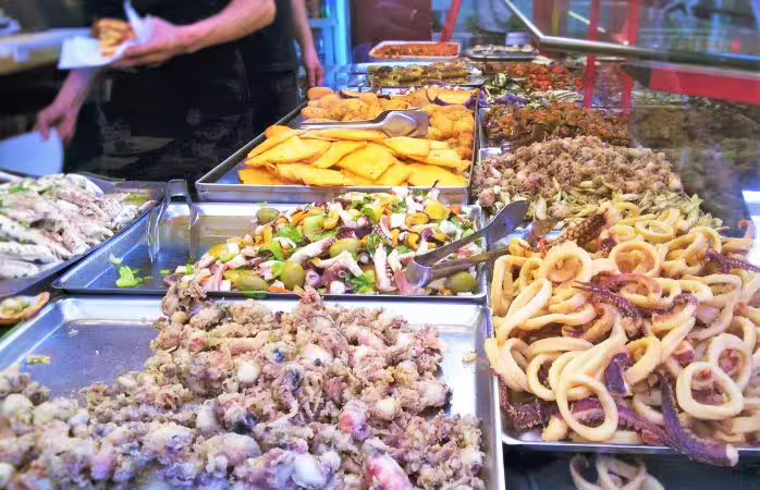 Traditional Sicilian street food buffet in Palermo with fried seafood, panelle and local specialties on a guided private tour