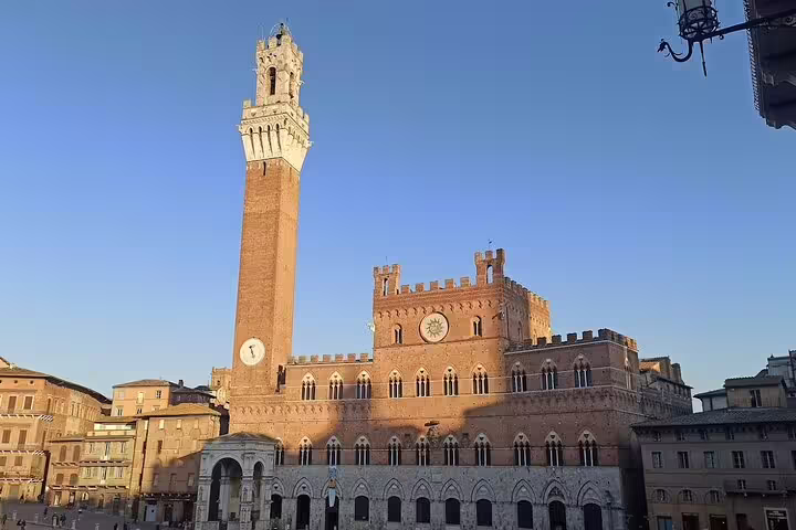 Piazza del Campo and Torre del Mangia in Siena at sunset, a highlight of Tuscany wine tours from Chianti to Montalcino