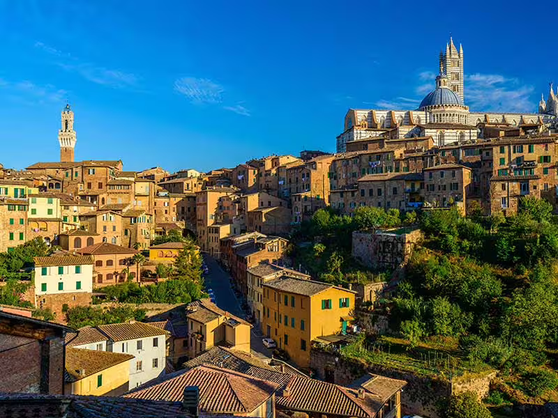 Panoramic view of Siena’s historic hilltop skyline in Tuscany, included on the 9 days self drive Divine Country culinary tour
