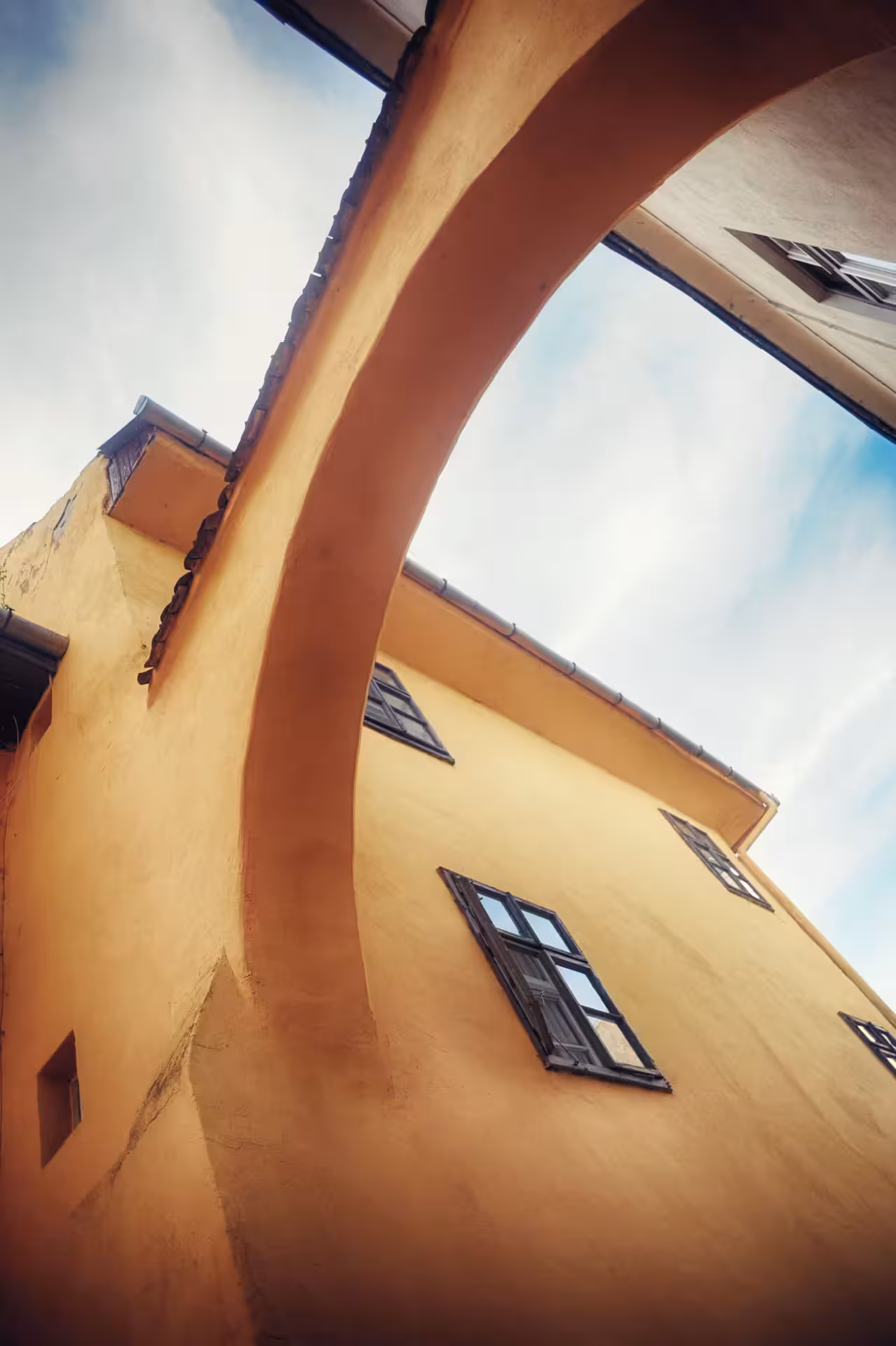 Charming archway and historic architecture in Sighisoara, ideal for exploring Dracula's birthplace by candlelight.