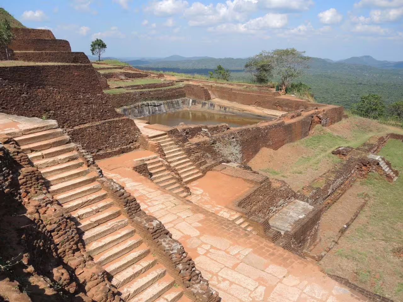 Ancient ruins and terraces at Sigiriya, showcasing historical architecture on the Dambulla tour.