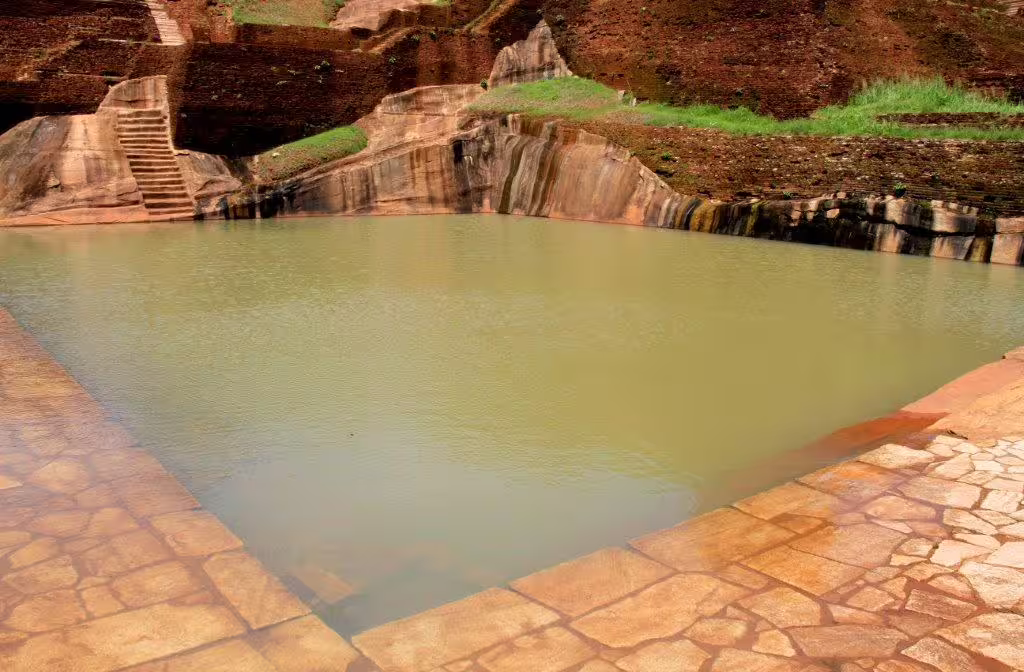 Discover the ancient Sigiriya rock pool surrounded by lush greenery, a marvel of Sri Lankan heritage.