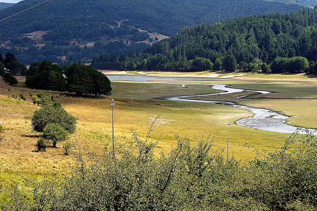 Summer landscape of Sila National Park with winding river, green meadows and forested hills, great for trekking and picnics