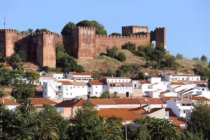 Explore the historic Silves Castle overlooking charming whitewashed houses on a private Algarve tour.