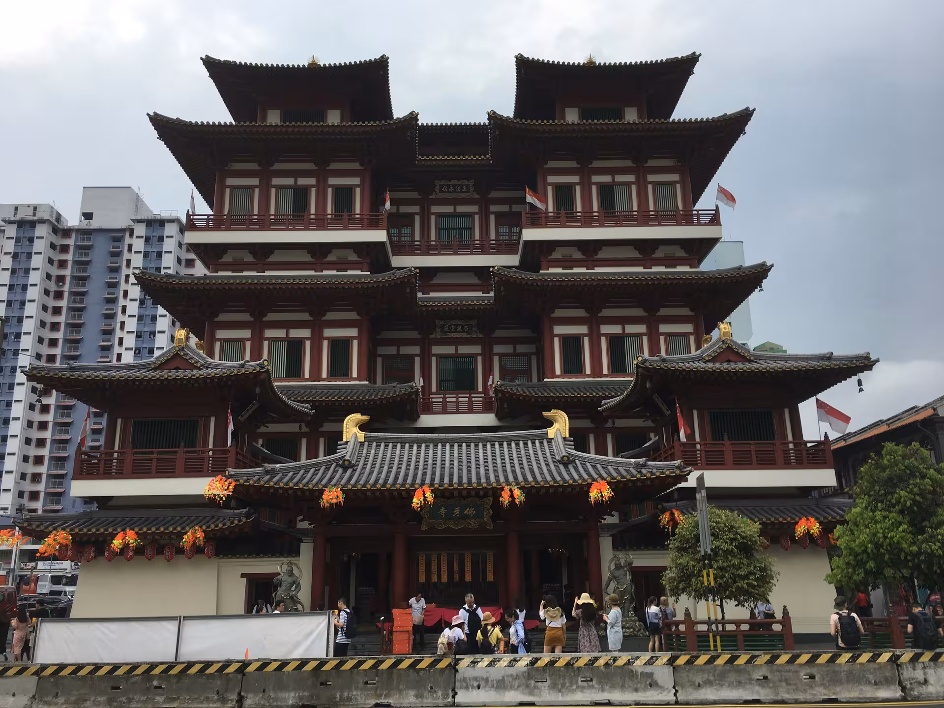 Majestic multi-tiered Buddhist temple with intricate architecture in Singapore's vibrant Chinatown.