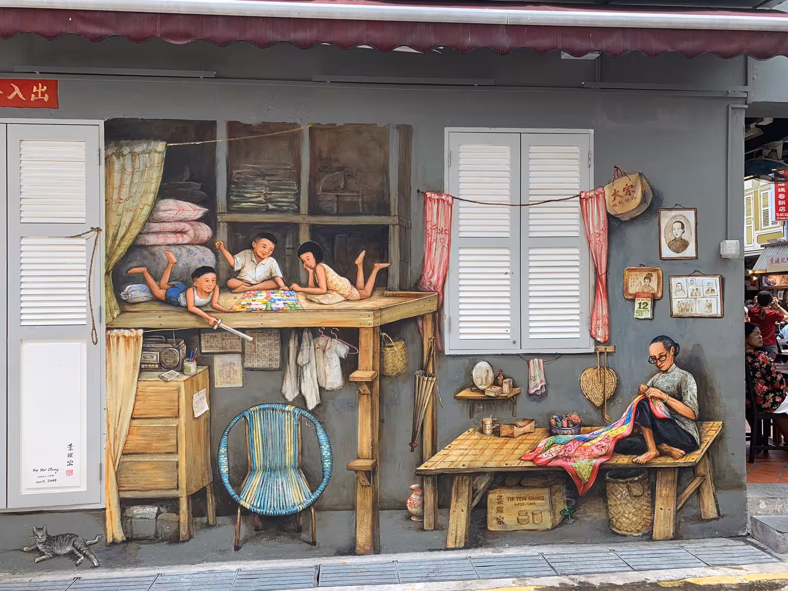 Detailed mural in Singapore's Chinatown depicting a nostalgic family scene with children and craftsman.