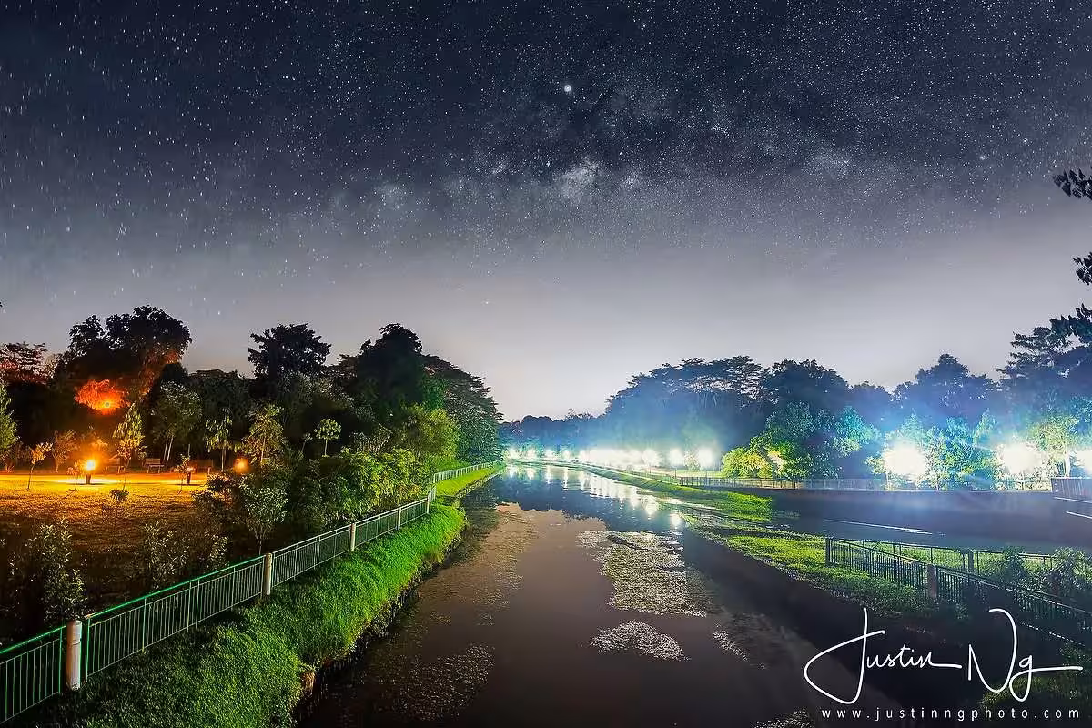 Stunning Milky Way view over a serene river in Singapore during a night photography tour with Justin Ng.