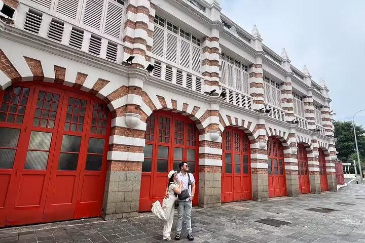 Couple exploring the historic Red Dot Design Museum in Singapore, a prime Crazy Rich Asians and Instagram photo spot.