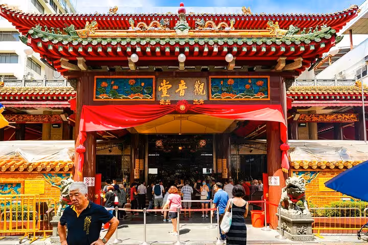 Entrance of a bustling Singaporean temple, inviting visitors for a spiritual exploration on a guided walking tour.