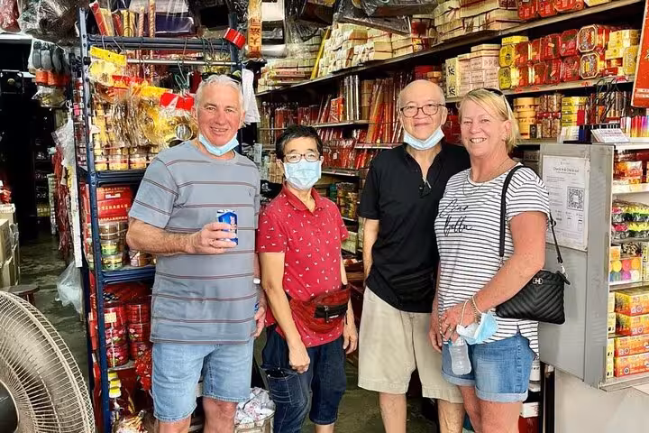Tourists explore a traditional Singaporean market filled with vibrant goods during the UNESCO Cultural Experience tour.