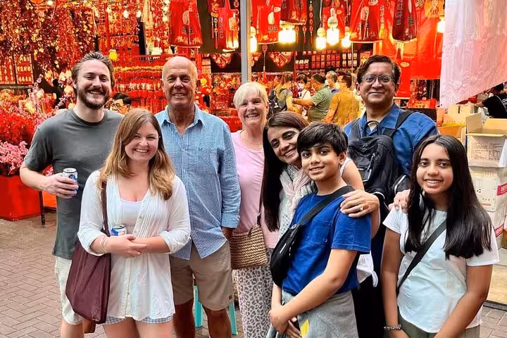 Group of tourists enjoying Singapore's cultural market during the UNESCO street food tour.