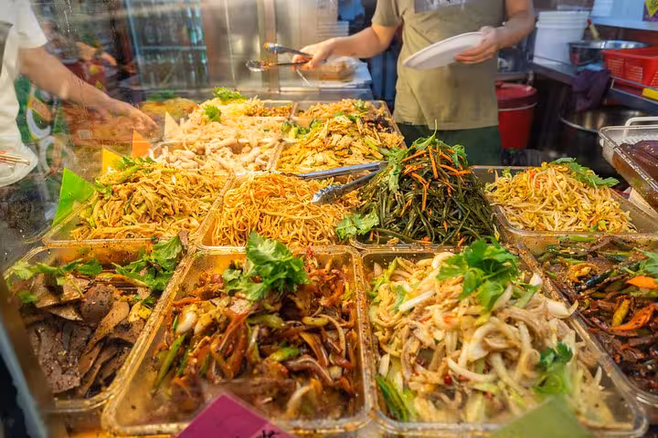 Vibrant Singapore street food stall with diverse dishes, showcasing the UNESCO cultural experience.