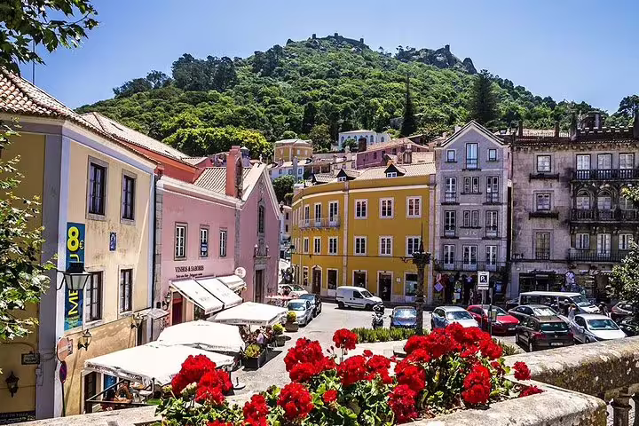 Charming Sintra townscape with colorful historic buildings and lush greenery, perfect for a Cabo da Roca, Cascais, and Estoril tour.