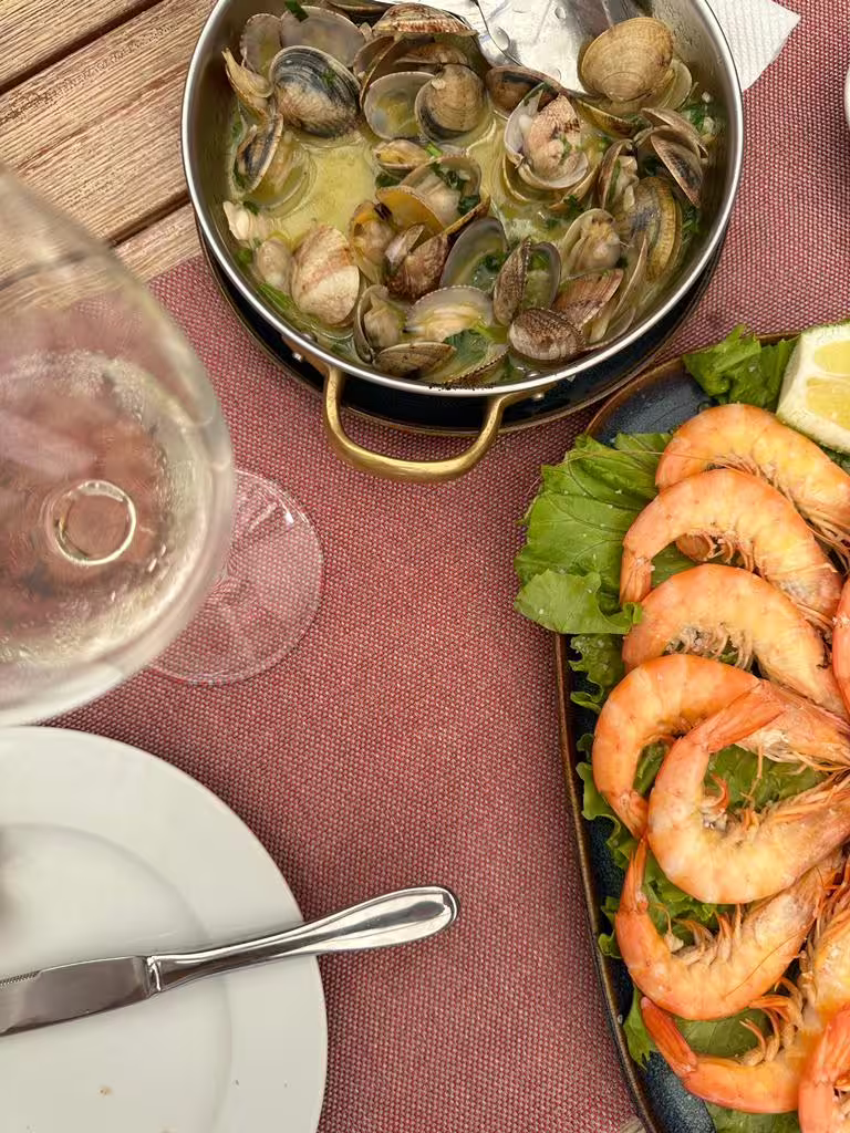 Delicious seafood platter with clams and grilled prawns, perfect for a Sintra & Cabo da Roca private van tour dining experience.