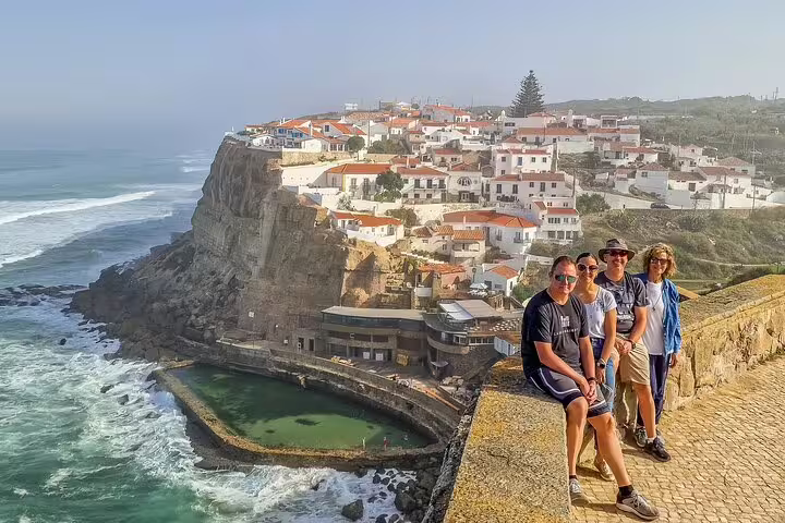 Tourists enjoy stunning ocean views and the charming cliffside village of Azenhas do Mar on a Sintra half-day tour from Lisbon.