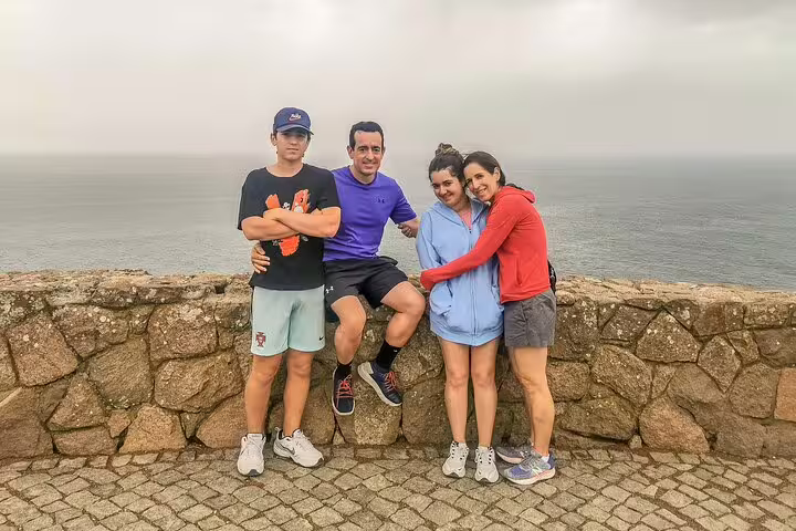 Group enjoying scenic ocean view during a half-day Sintra sightseeing tour from Lisbon, perfect for nature and culture lovers.