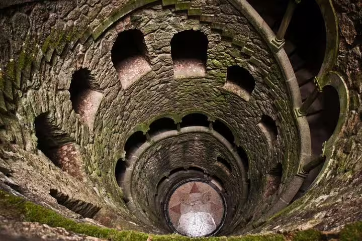 Explore the enchanting spiral staircase of the Initiation Well in Sintra on a customizable full-day tour with a private driver.
