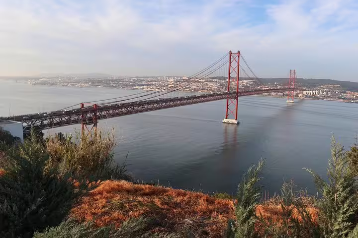Admire the stunning views of the 25 de Abril Bridge during the Sintra, Cascais and Pena Palace tour from Lisbon.