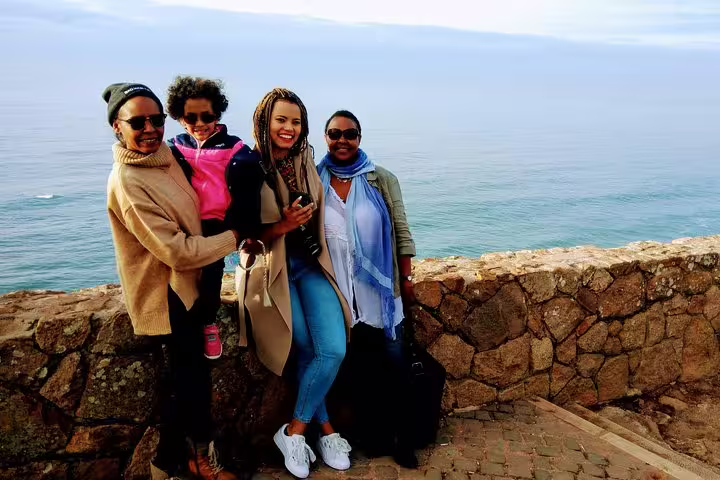 Group enjoying scenic ocean view on the Sintra World Heritage and Cascais Village Private Luxury Tour, perfect for families.