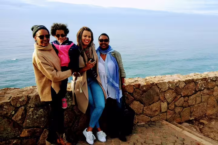 A group enjoys scenic ocean views on the Sintra World Heritage and Cascais Village Tour, perfect for a memorable Portugal adventure.