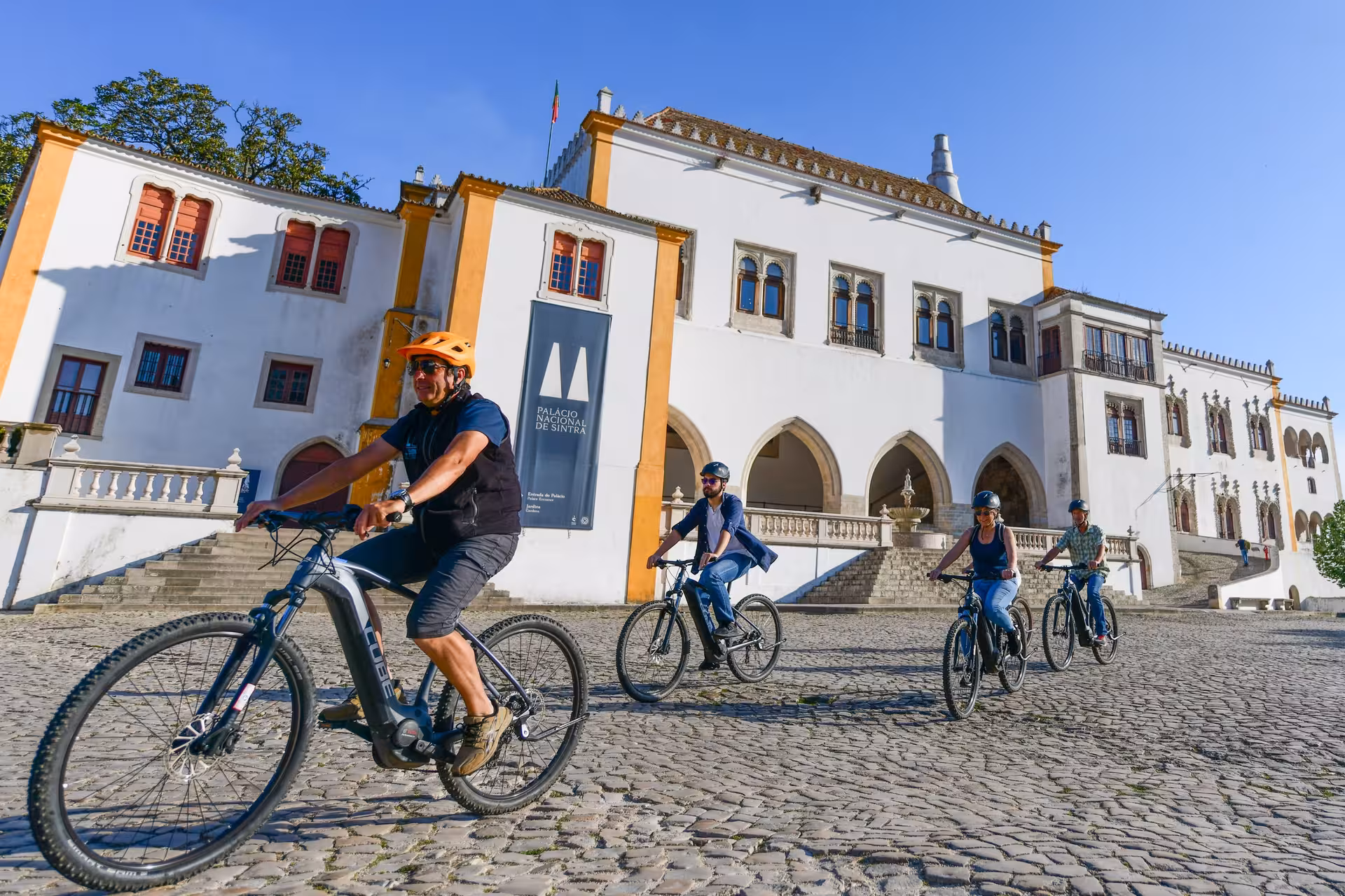 Cyclists explore the historic Sintra National Palace on the Sintra 5 Senses e-Bike Tour.