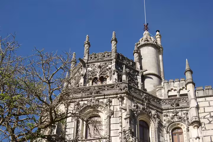 Intricate Gothic architecture of Sintra's historic palace under a clear blue sky.