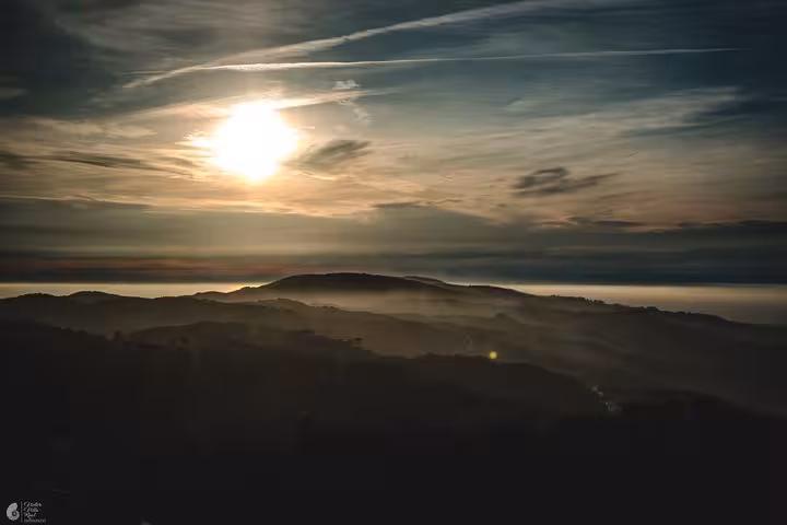 Sunset over misty Sintra hills, panoramic viewpoint on a self-drive tour covering all monuments and landmarks