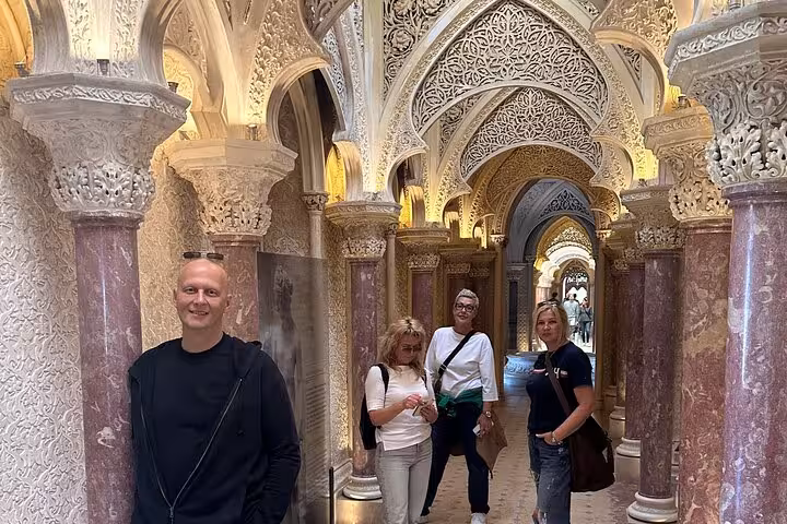 Visitors admire intricate Moorish architecture inside a lavishly decorated hall on a Sintra private tour.