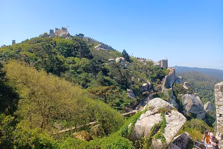 View of Sintra’s Moorish Castle walls over lush hills, a highlight on the Tuk Tuk Tour Sintra Cascais