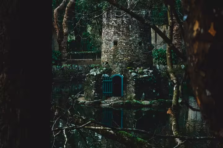 Mossy stone tower by a pond in Sintra forest, a hidden gem view on the self-drive tour of monuments