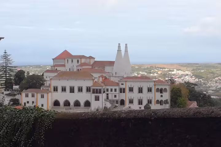 Scenic view of Sintra National Palace with iconic chimneys, perfect for a private tour from Lisbon or Cascais.