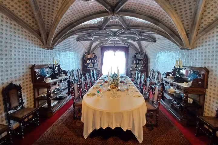 Elegant dining room inside Sintra palace on tuk tuk tour, vaulted ceiling and set banquet table