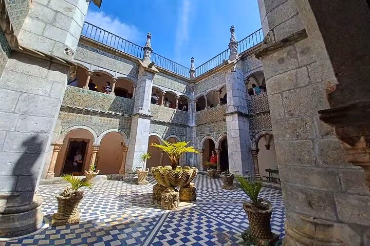 Moorish-style courtyard at Sintra palace on tuk tuk tour, tiled floor, arches and central fountain