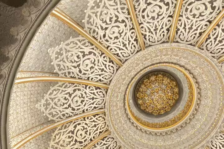 Intricate ornate ceiling design in Sintra's historic palace, showcasing Moorish-inspired architecture and craftsmanship.