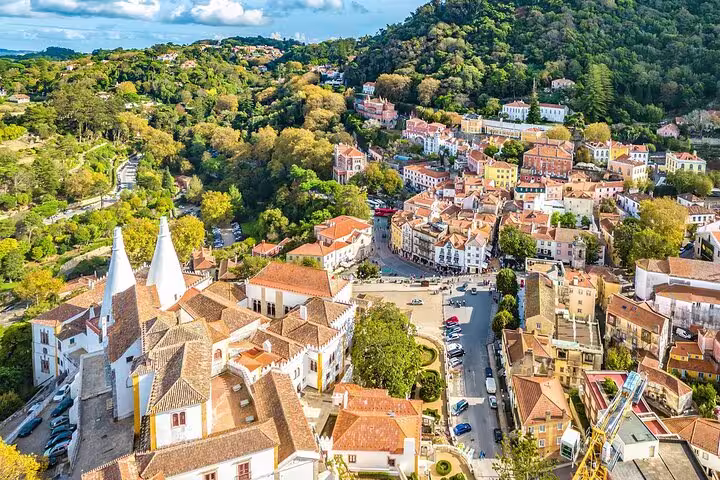 Aerial view of Sintra's charming town with historic buildings and lush hills, ideal for a picturesque small-group tour.