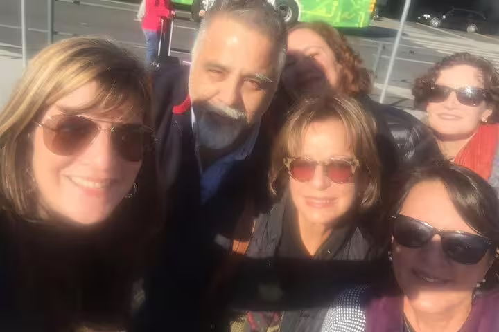 A group of happy tourists enjoys a sunny day on the Sintra, Pena Palace, and Cascais full-day tour from Lisbon.