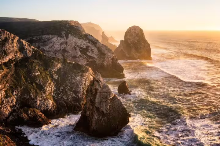 Dramatic coastal cliffs at sunset near Sintra, Portugal, showcasing the natural beauty explored on the Pena Palace and Regaleira tour.